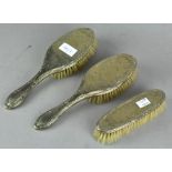 A set of three silver plate dressing table brushes,