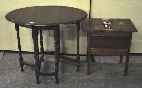 A 20th century wooden sewing table with sliding top opening to reveal sewing related contents