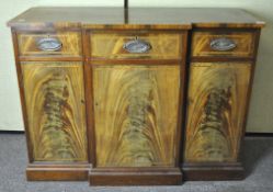 A mahogany veneered sideboard with inlaid borders, three drawers above three cupboards,