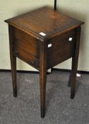 An oak sewing box, with opening top over a single drawer,