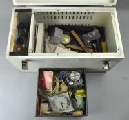 A white metal trunk containing clock and watch items