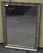 A contemporary rectangular Mirror with silvered floral frame,