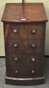 A Victorian mahogany pot cupboard with four faux draws forming the door,