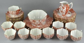 A late 19th/early 20th century part tea set, orange floral motifs on a white ground,