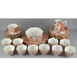 A late 19th/early 20th century part tea set, orange floral motifs on a white ground,