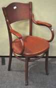 A vintage bent wood armchair with crocodile skin style detailing to seat and back,