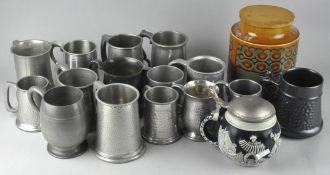 A large collection of assorted pewter tankards and mugs, some with hammered decoration,