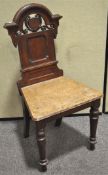 A 19th century oak hall chair with shield back