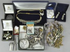 A large assortment of costume jewellery, including a variety of silver items; two ingots, a cross,