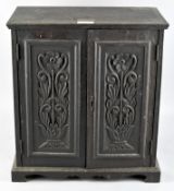 An oak carved smokers cabinet,