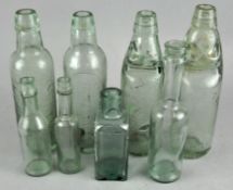 A group of assorted glass bottles,