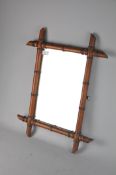 A vintage faux bamboo framed mirror, possibly French,