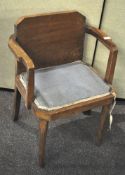 An Art Deco desk chair, with plain veneered back and upholstered seat,