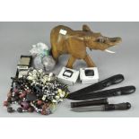 A collection of tribal items, to include carved wooden elephant, beads and necklaces,