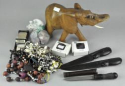 A collection of tribal items, to include carved wooden elephant, beads and necklaces,
