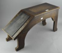 An early 20th century oak shoe shiners stool, with original detailing and label to front,