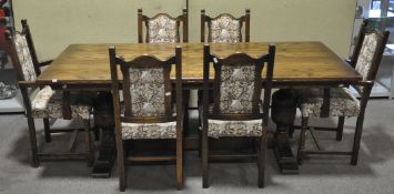 A large oak refectory table, raised upon two large turned supports,