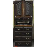 A mahogany cupboard, the base with two short and three long drawers,