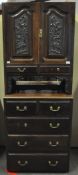 A mahogany cupboard, the base with two short and three long drawers,