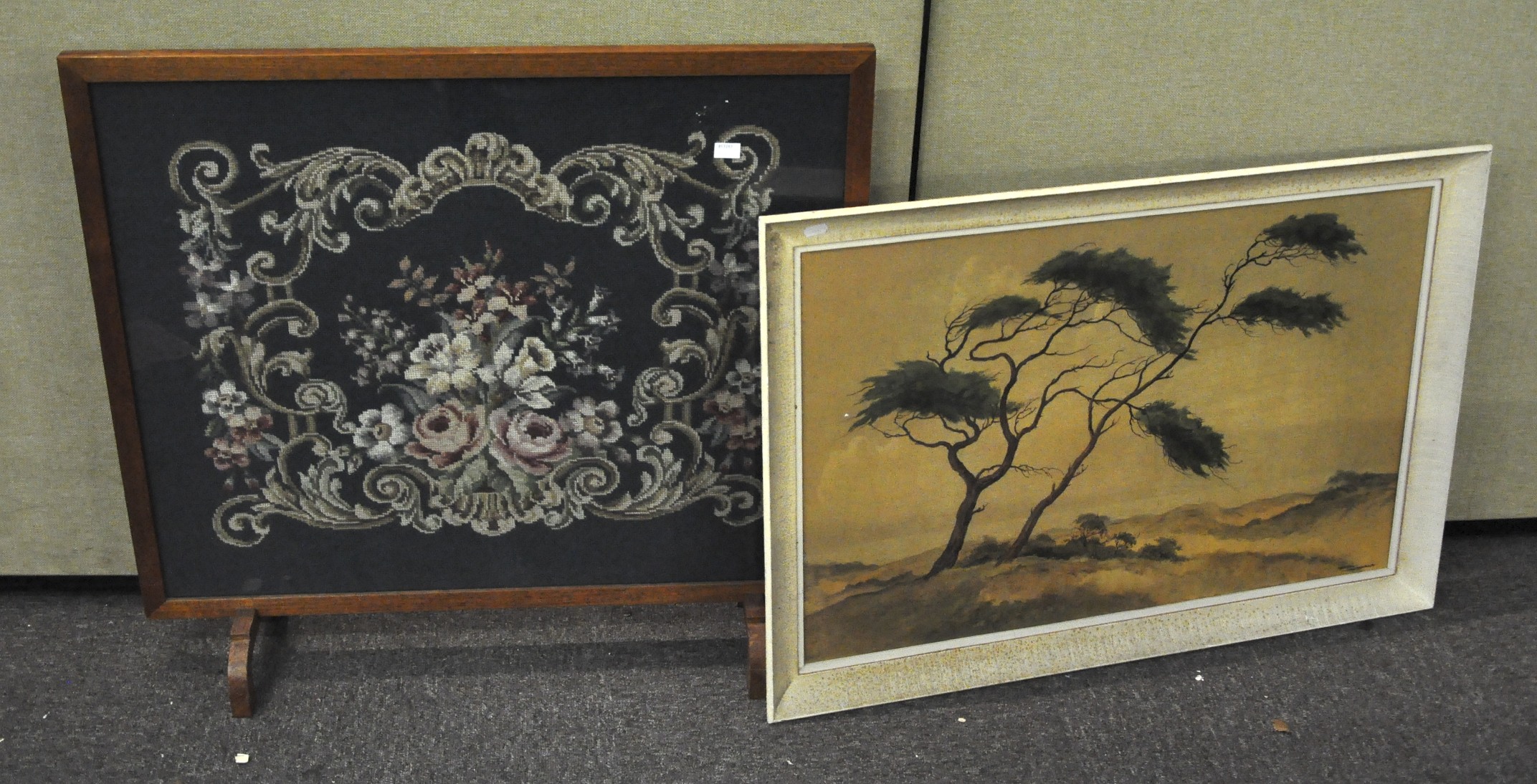 An oak framed fire screen with a floral needlework panel set to centre, 75cm high x 18cm wide,