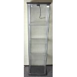 A modern glass display cabinet of rectangular form, four tier,