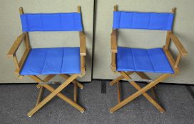 A pair of folding captains chairs with cushioned seat,