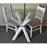 A circular glass topped breakfast table, on white crossed leg frame,