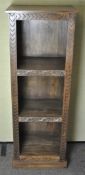A three tier hardwood bookcase with engraved borders,