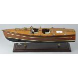A wooden model of a Speedboat, raised on stand,