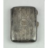 A George V silver cigarette case of rounded rectangular form, opening to reveal a gilt interior,