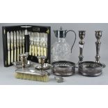 A collection of assorted silver plated items, including two pairs of candlesticks, a claret jug,