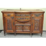 A mahogany sideboard with carved motifs to the front,