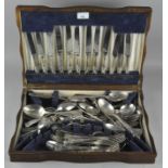 An early 20th century oak canteen containing silver plated cutlery,