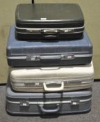 A group of four vintage suitcases, all with working clasps,