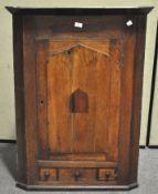 A George III oak and walnut corner cabinet, with single drawer,