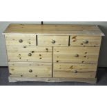 A large pine chest of drawers, three short over four long,