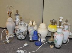 A group of table lamps, mostly ceramic, and including an oil lamp,