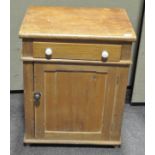 A stripped pine cupboard, a single drawer above a panelled door,