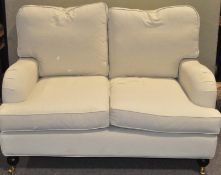 A modern two seat sofa, with caster to the two front feet,