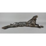 A bronzed metal figure of a reclining hare