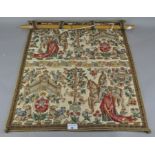 A wall hanging depicting a traditional scene,