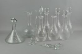 A collection of glass items, comprising seven decanters and one claret jug,