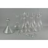 A collection of glass items, comprising seven decanters and one claret jug,