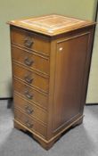 A mahogany and leather inset three drawer filing cabinet,