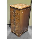 A mahogany and leather inset three drawer filing cabinet,