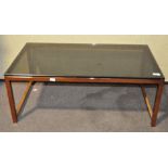 A glass topped coffee table, of rectangular form,