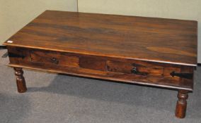 A heavy hard wood coffee table, by John Lewis, with two drawers either side,