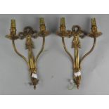 A pair of gilt metal two branch wall lights,