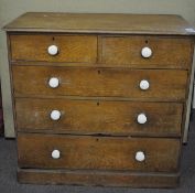 An early 20th century oak chest of two short over three long drawers, with ceramic knobs,