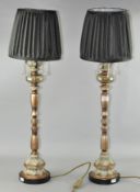 A pair of large ornate table lamps, with shades,